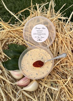 A cup of Squire Farms soft cheese on straw